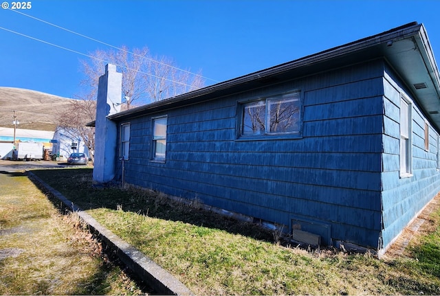 view of side of home featuring a yard