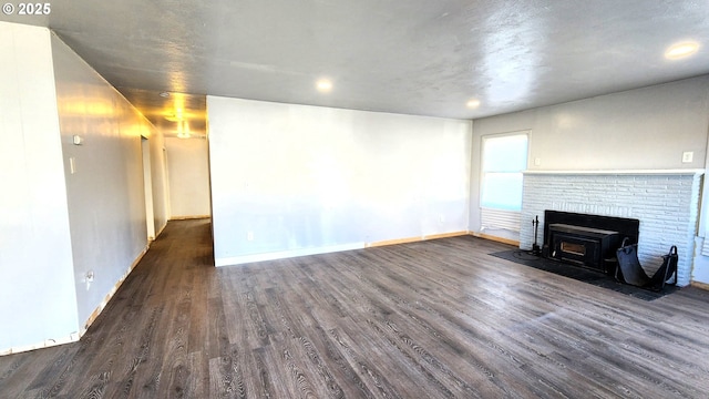 unfurnished living room featuring dark hardwood / wood-style floors and a fireplace