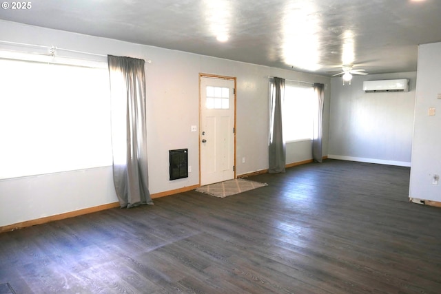 foyer featuring dark hardwood / wood-style floors, a wall mounted air conditioner, and ceiling fan