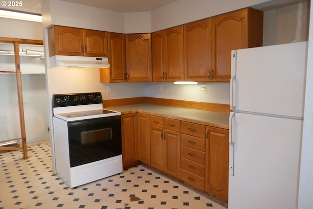 kitchen with range with electric cooktop and white fridge