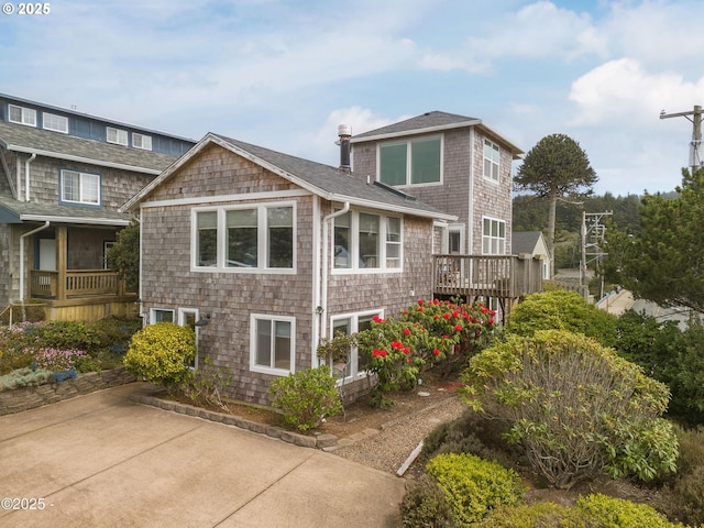 3158 SW Beach Ave, Lincoln City, OR 97367 - view of side of property with a deck and a shingled roof