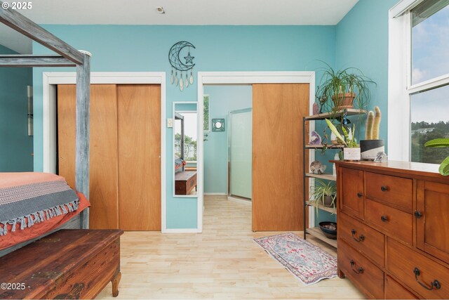 3158 SW Beach Ave, Lincoln City, OR 97367 - bedroom with light wood-style flooring, a chandelier, and baseboards
