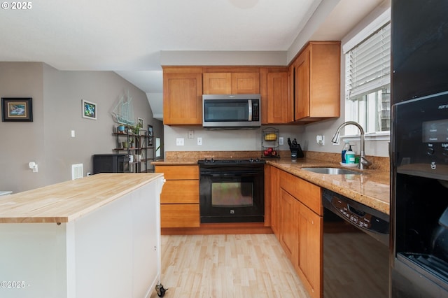 3158 SW Beach Ave, Lincoln City, OR 97367 - kitchen featuring black appliances, a sink, butcher block countertops, light wood-type flooring, and brown cabinets