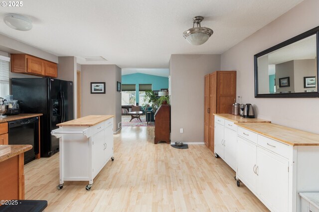 3158 SW Beach Ave, Lincoln City, OR 97367 - kitchen featuring wood counters, black appliances, light wood-style flooring, and white cabinets