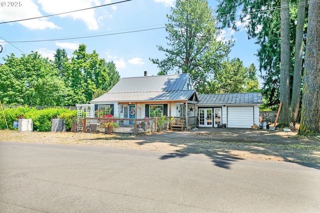 91051 S Coleman St, Eugene, OR 97408 - view of front facade featuring french doors, a garage, driveway, a porch, and metal roof