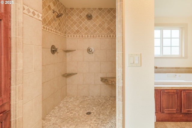 bathroom with a bath and tiled shower