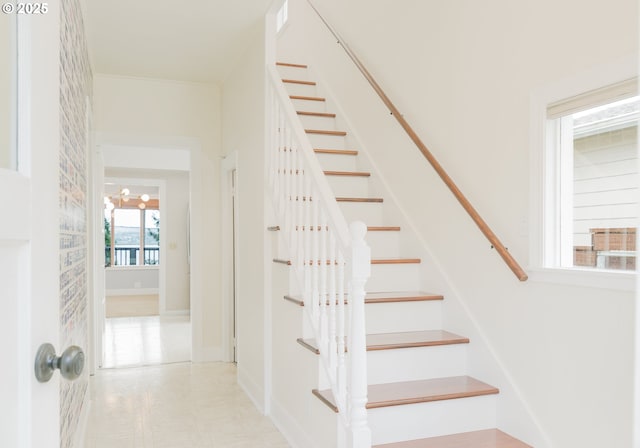 stairs featuring crown molding