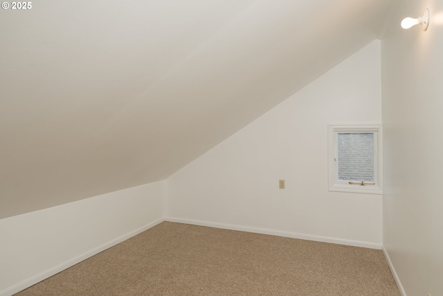 bonus room featuring lofted ceiling, baseboards, and light colored carpet