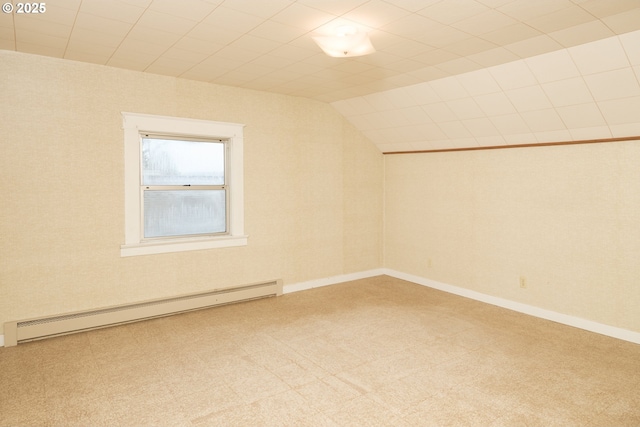 unfurnished room featuring a baseboard radiator, baseboards, vaulted ceiling, and carpet flooring