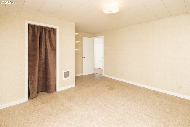 unfurnished bedroom featuring light floors, visible vents, and baseboards