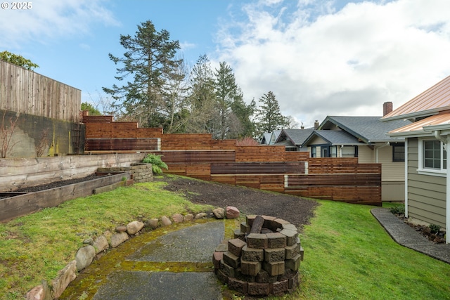 view of yard featuring an outdoor fire pit and fence private yard