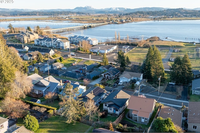 drone / aerial view with a residential view and a water and mountain view