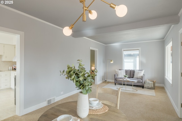 dining room with light carpet, visible vents, and a wealth of natural light