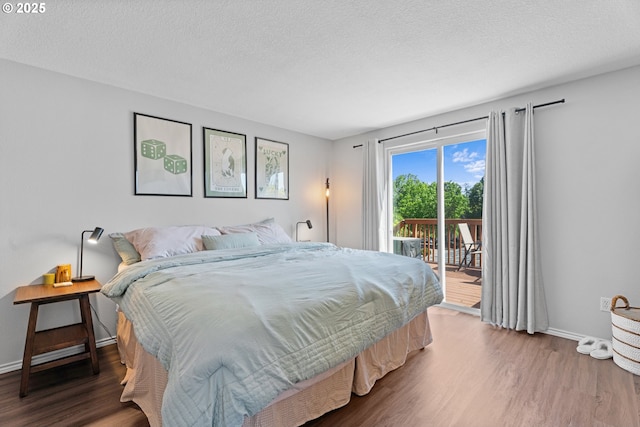 3218 SW Corbeth Ln, Troutdale, OR 97060 - bedroom featuring access to outside, wood finished floors, baseboards, and a textured ceiling