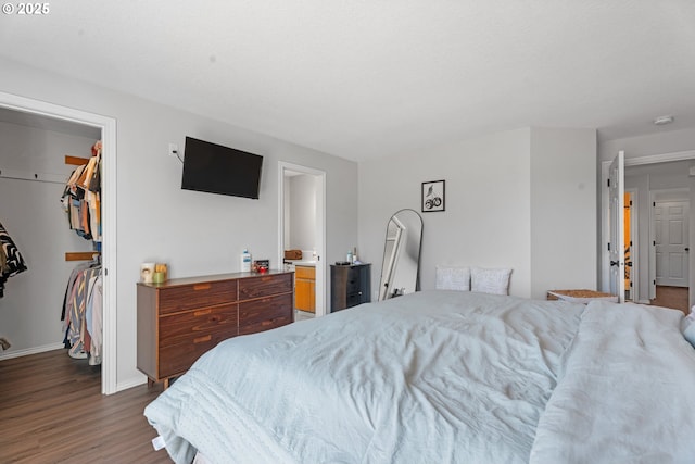 3218 SW Corbeth Ln, Troutdale, OR 97060 - bedroom featuring wood finished floors, a walk in closet, a closet, and baseboards