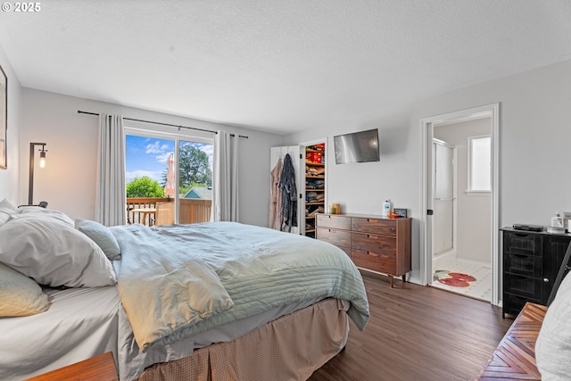3218 SW Corbeth Ln, Troutdale, OR 97060 - bedroom featuring wood finished floors, access to outside, a walk in closet, and connected bathroom