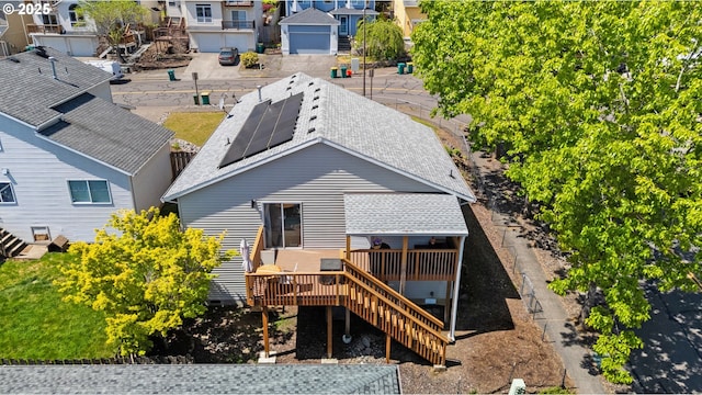 3218 SW Corbeth Ln, Troutdale, OR 97060 - back of property with a deck, roof mounted solar panels, roof with shingles, stairs, and a residential view