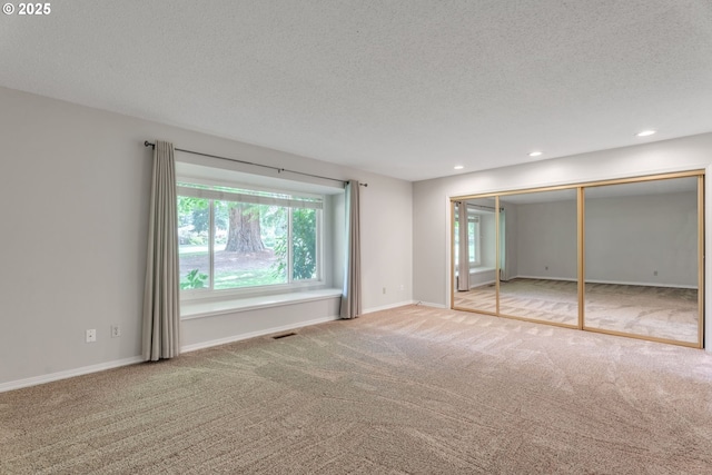 8085 SW Fairway Dr, Wilsonville, OR 97070 - unfurnished bedroom featuring carpet floors, multiple windows, a textured ceiling, and recessed lighting