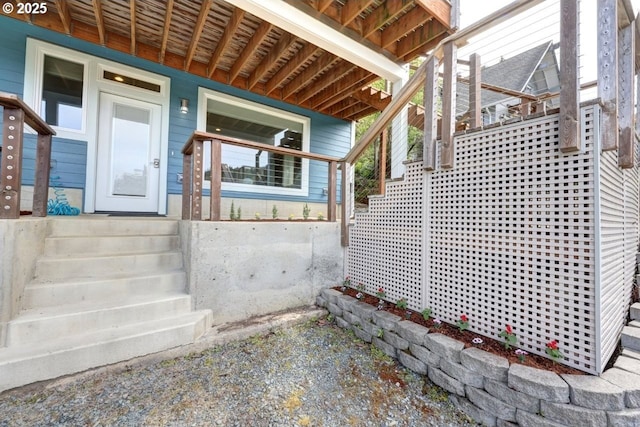 view of exterior entry with covered porch