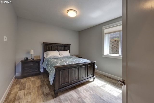 bedroom featuring baseboards and wood finished floors