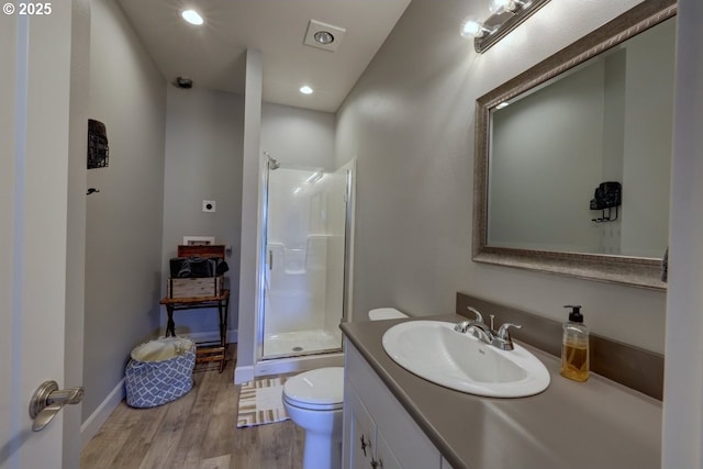 full bathroom with vanity, toilet, recessed lighting, wood finished floors, and a stall shower
