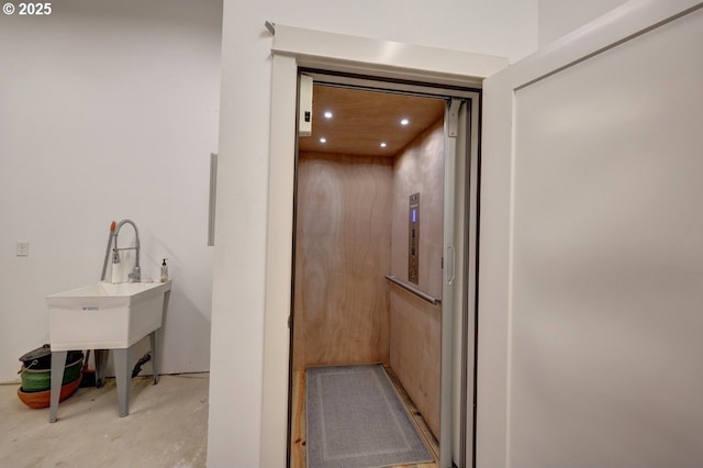 hallway featuring recessed lighting and elevator