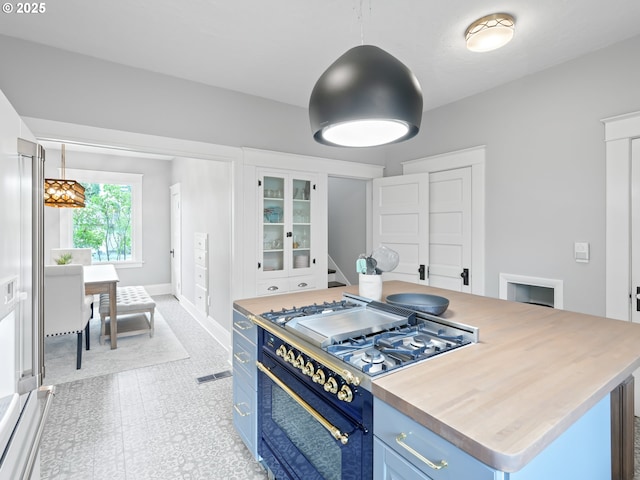 3327 4th St, Hubbard, OR 97032 - kitchen featuring gas range oven, blue cabinets, light countertops, and glass insert cabinets