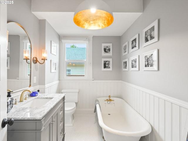 3327 4th St, Hubbard, OR 97032 - full bath with wainscoting, vanity, a freestanding tub, tile patterned floors, and toilet