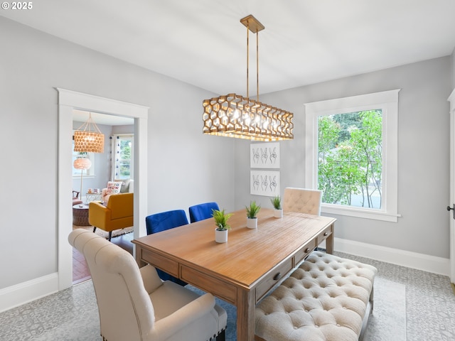 3327 4th St, Hubbard, OR 97032 - dining space featuring a chandelier and baseboards