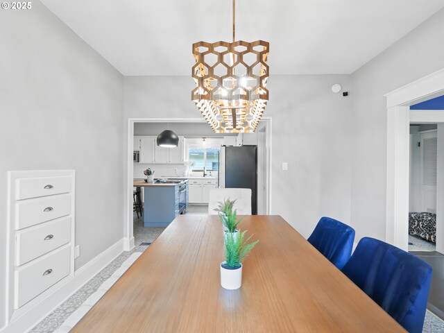 3327 4th St, Hubbard, OR 97032 - dining room featuring baseboards and a chandelier