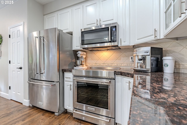 32153 SE Bluff Rd, Gresham, OR 97080 - kitchen with appliances with stainless steel finishes, white cabinets, backsplash, and wood finished floors