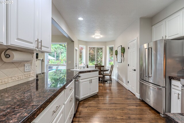 32153 SE Bluff Rd, Gresham, OR 97080 - kitchen featuring high end refrigerator, a textured ceiling, white cabinets, dark wood-type flooring, and decorative backsplash