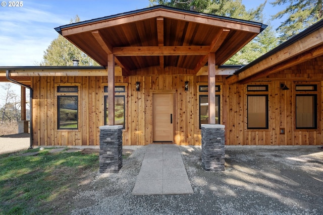 property entrance featuring board and batten siding