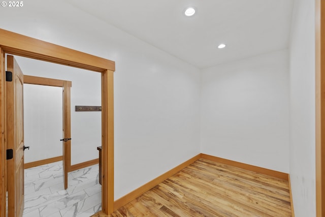 spare room featuring marble finish floor, recessed lighting, and baseboards