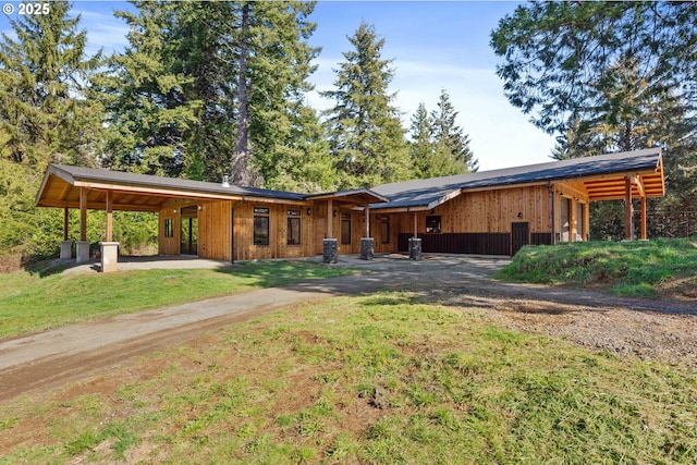 view of front of home featuring driveway and an attached carport