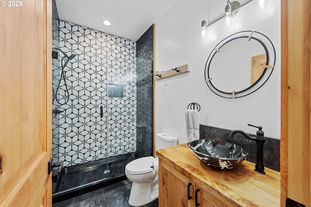 bathroom with a stall shower, vanity, toilet, and recessed lighting