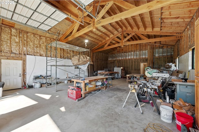 interior space featuring high vaulted ceiling and a garage