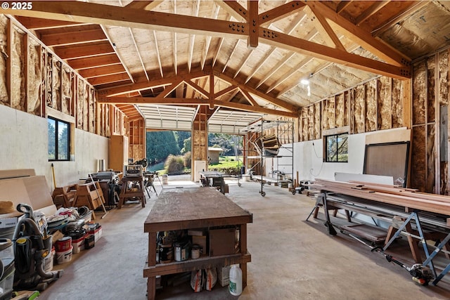 misc room with high vaulted ceiling and concrete flooring