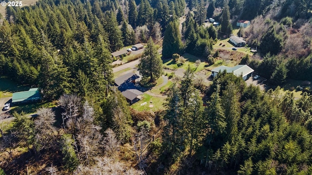 birds eye view of property with a wooded view