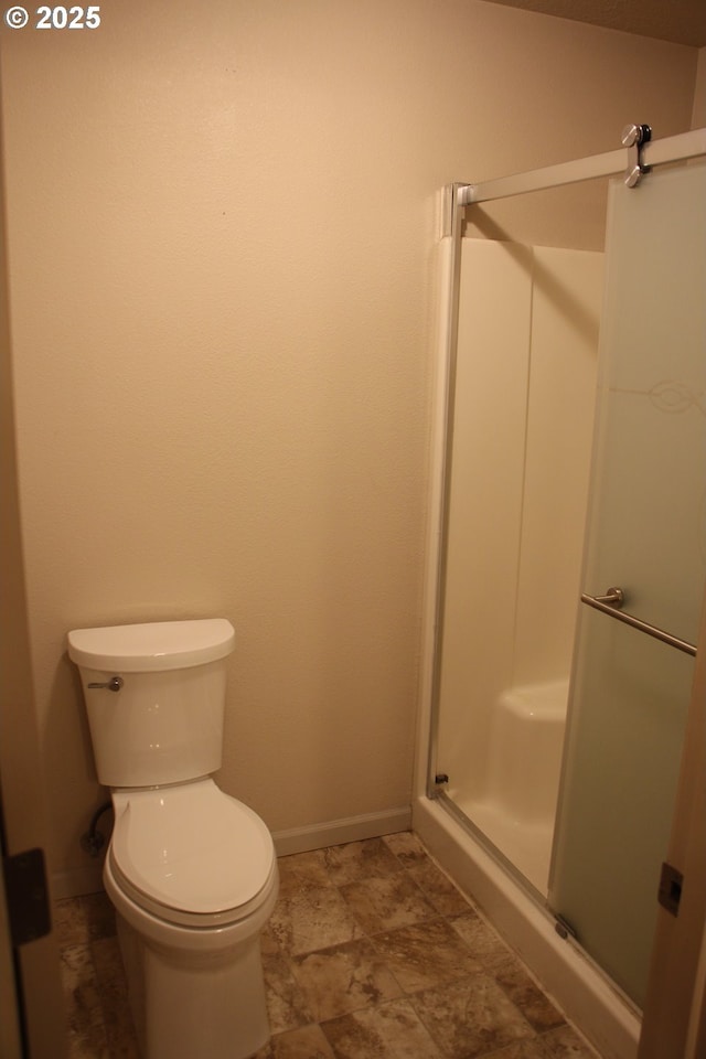 bathroom with walk in shower and toilet