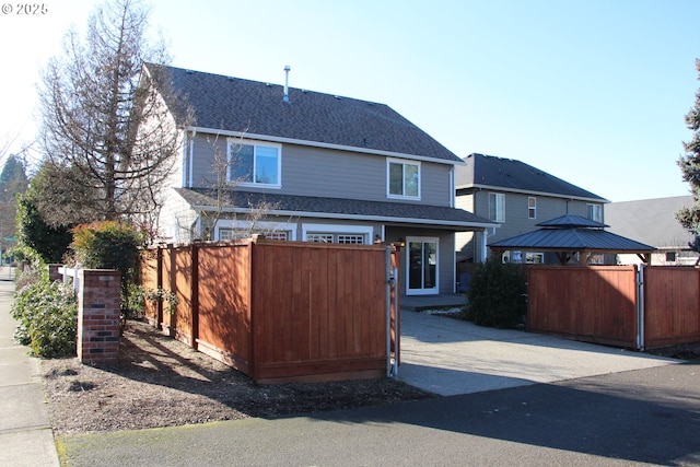 back of property with a gazebo