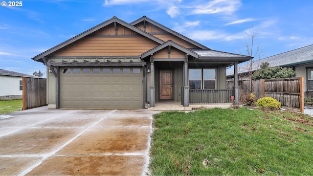 view of front of home featuring an attached garage, board and batten siding, fence, driveway, and a front lawn