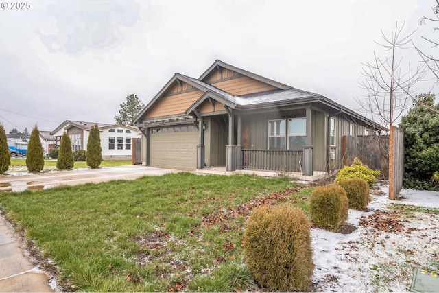 view of front of home with a garage, driveway, covered porch, board and batten siding, and a front yard