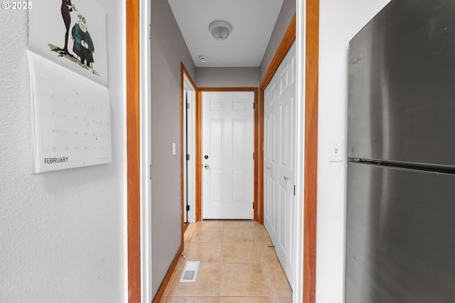 corridor with visible vents and light tile patterned floors