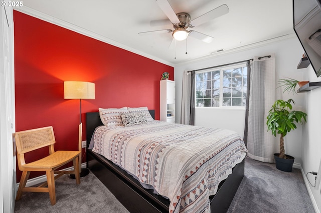 carpeted bedroom with ornamental molding, visible vents, ceiling fan, and baseboards