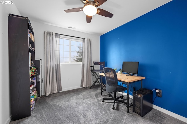 home office featuring a ceiling fan, carpet, visible vents, and baseboards