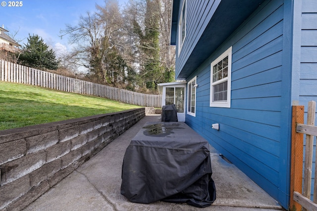 view of patio featuring a sunroom, a fenced backyard, and grilling area