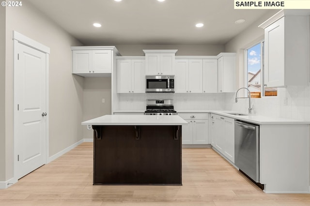 3118 S Magnolia Dr Unit Lt752, Cornelius, OR 97113 - kitchen with appliances with stainless steel finishes, a sink, white cabinetry, a center island, and recessed lighting