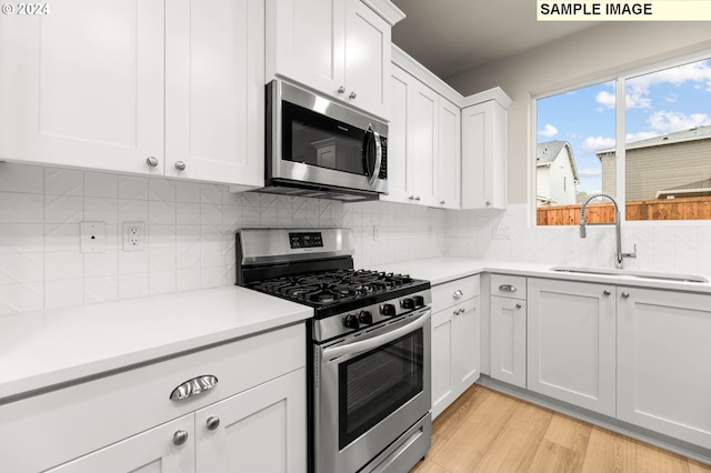 3118 S Magnolia Dr Unit Lt752, Cornelius, OR 97113 - kitchen with stainless steel appliances, a sink, light countertops, and white cabinets