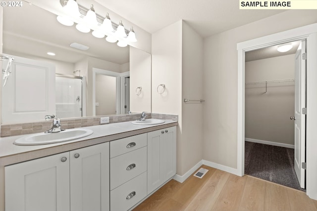 3118 S Magnolia Dr Unit Lt752, Cornelius, OR 97113 - bathroom featuring a stall shower, a spacious closet, wood finished floors, double vanity, and baseboards